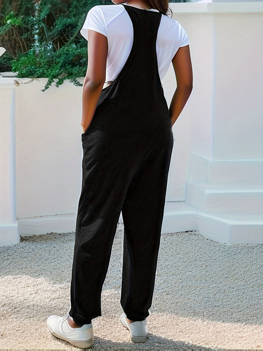 Black heathered loose fit jumpsuit with spaghetti straps and pockets.