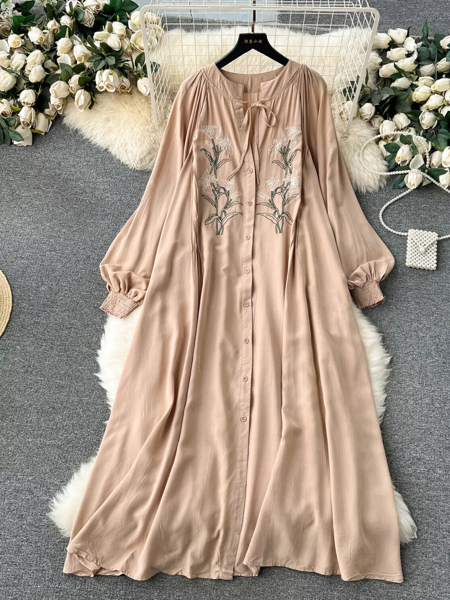 Khaki embroidered floral maxi dress with tie neck and button front.