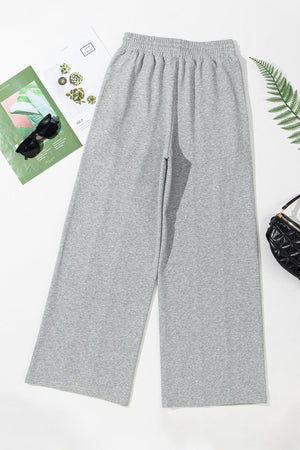 Gray seamed wide leg lounge trousers with elastic waistband and relaxed fit.
