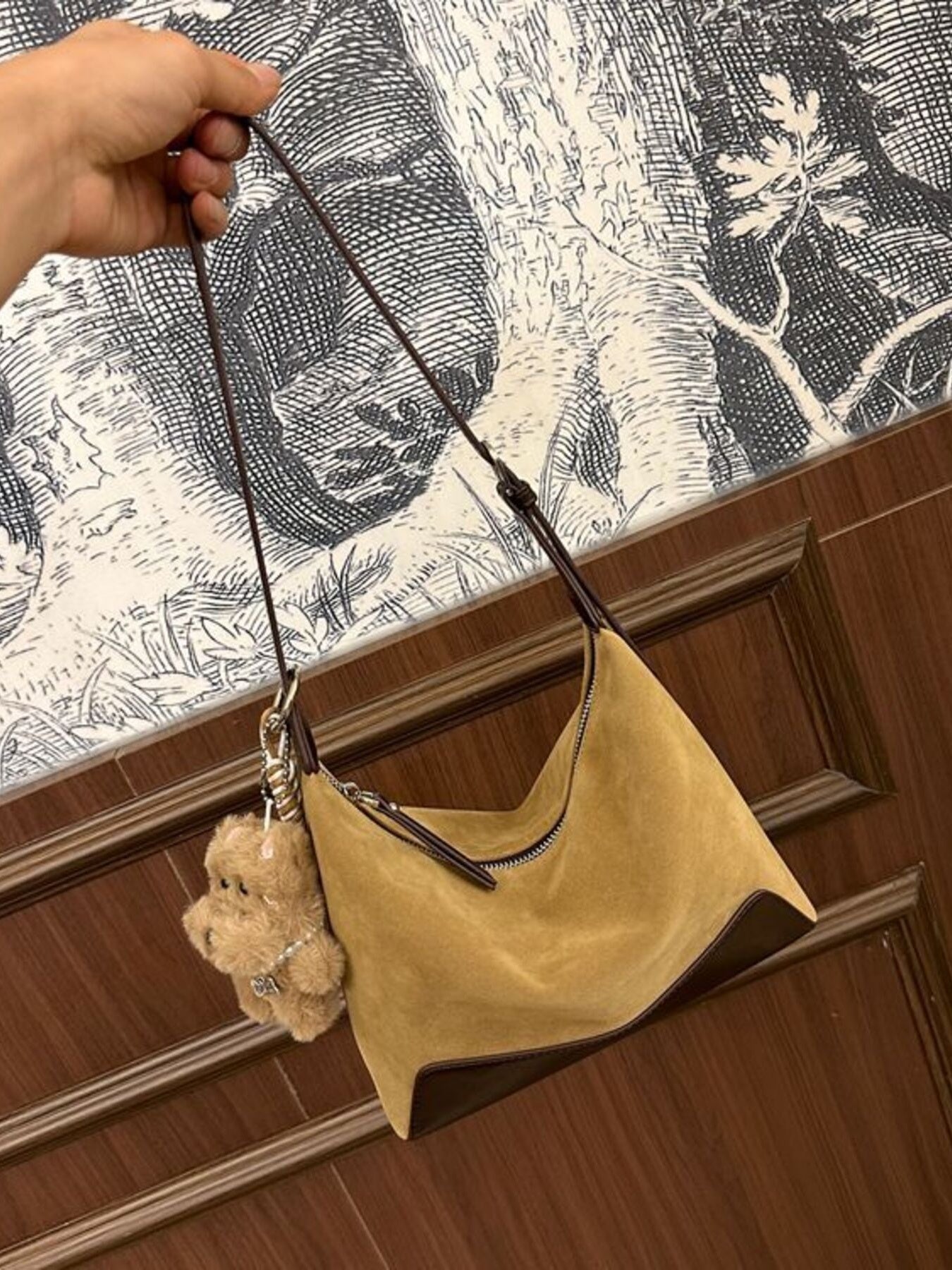 Tan suede crossbody bag with zipper and teddy bear charm