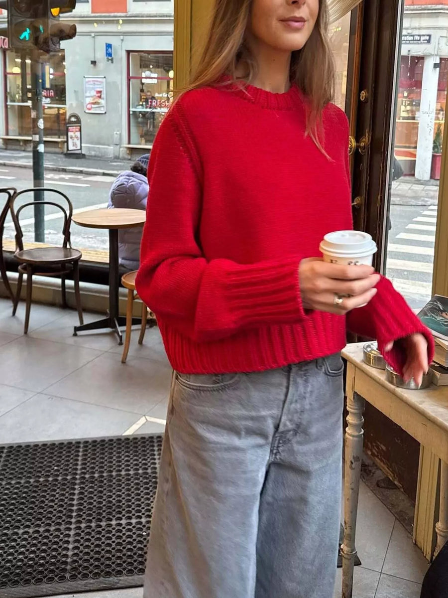 Red ribbed round-neck knit sweater with cuffed sleeves and hem.