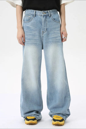 Oversized wash denim palazzo trousers in medium blue with a faded effect.