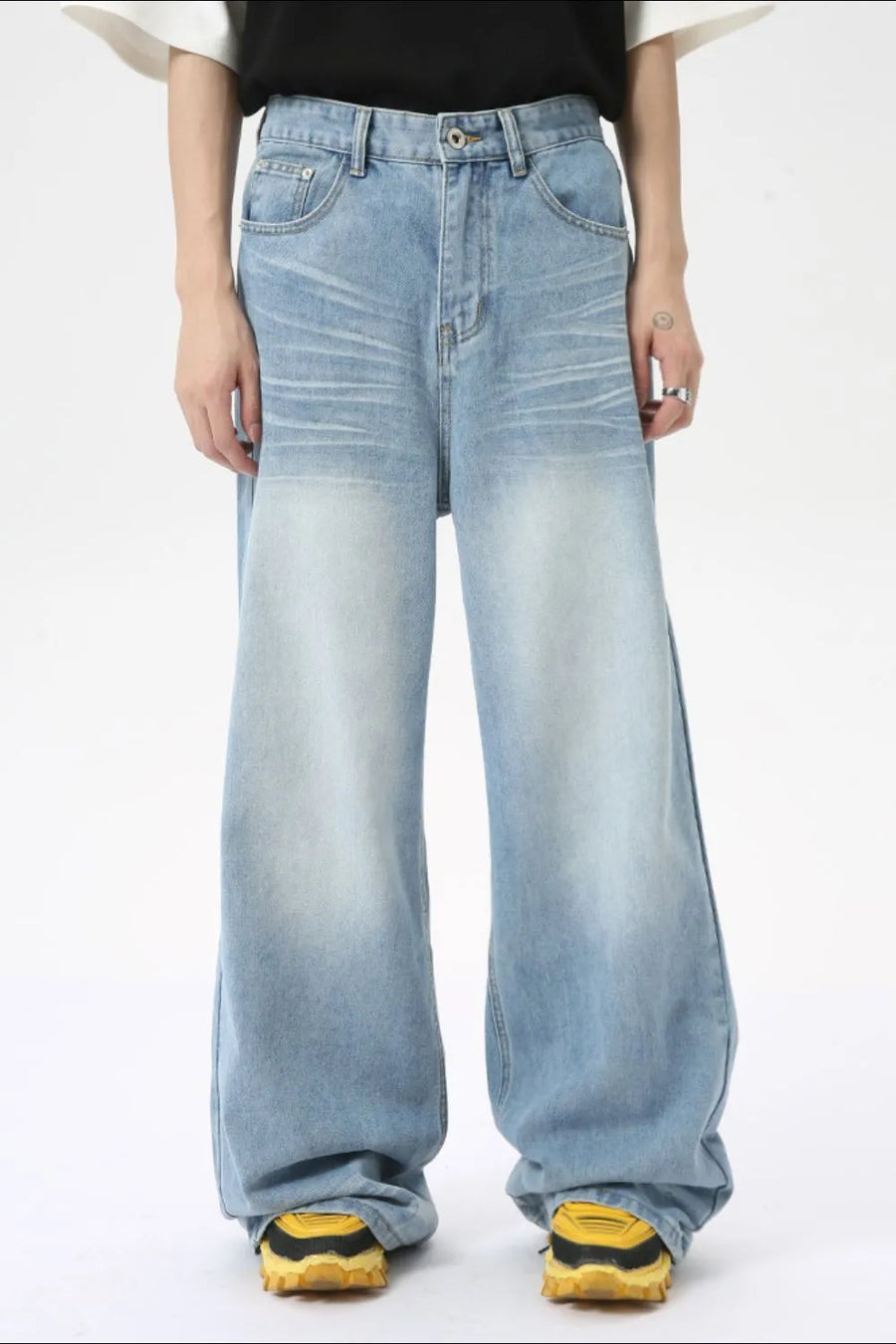 Oversized wash denim palazzo trousers in medium blue with a faded effect.