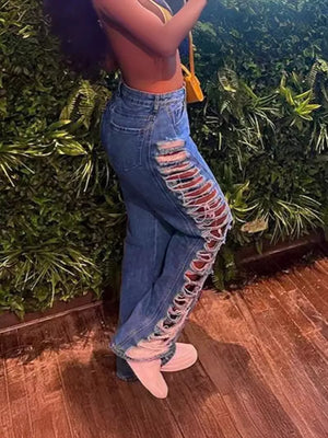 Blue cotton blend jeans with distressed side cutouts and lace-up detail.