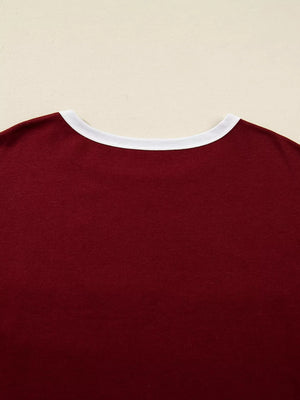 Burgundy long-sleeve top with white trim neckline.