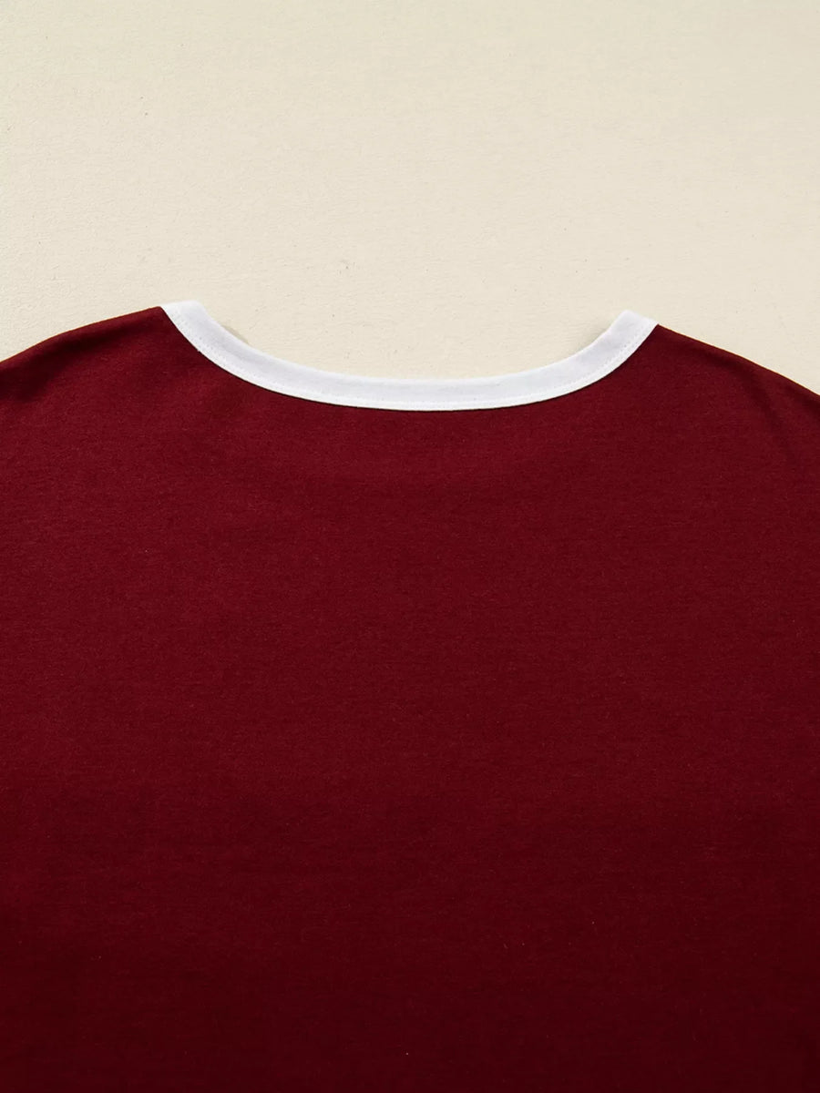 Burgundy long-sleeve top with white trim neckline.