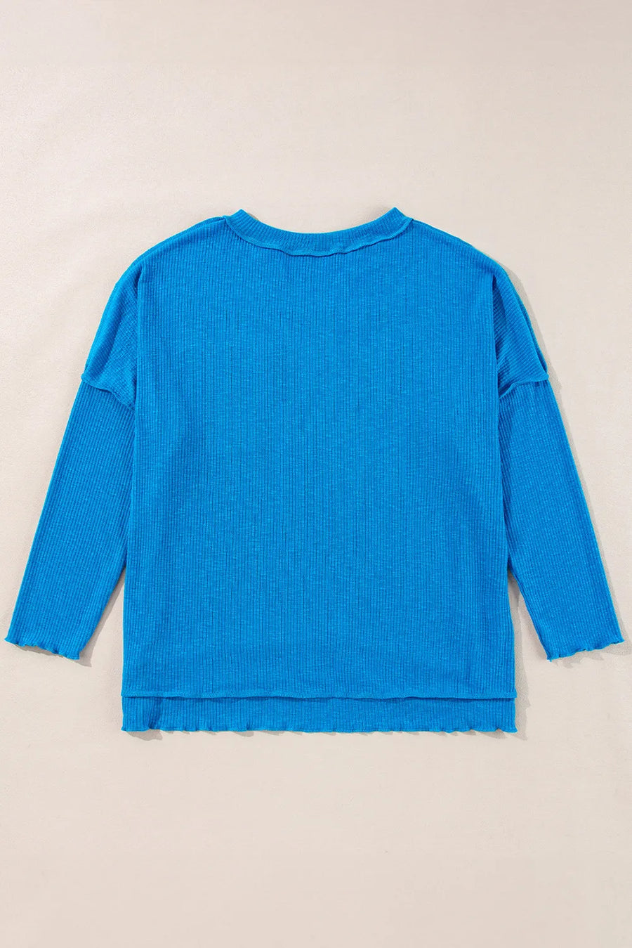 Sky blue textured thermal top with cutout neckline and lettuce hem details.