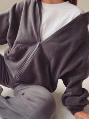 Dark Gray fleece zip-up hoodie with front pocket, worn over a white t-shirt.