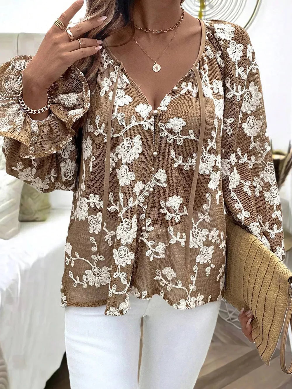 Coffee brown sheer blouse with white floral embroidery, long sleeves, and button front.