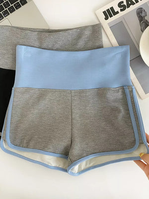 Light blue and gray athletic shorts with contrast trim and high-rise waist.