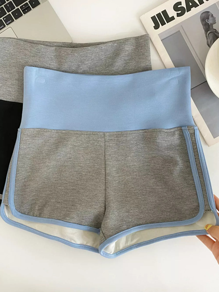 Light blue and gray athletic shorts with contrast trim and high-rise waist.
