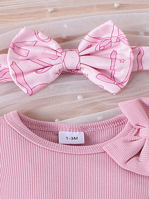 Pink ribbed cotton baby bodysuit with bow detail and matching bowknot headband.