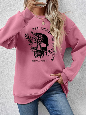 Blush Pink raglan sweatshirt with floral skull graphic and text.
