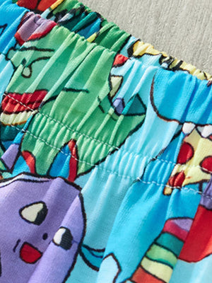 Toddler shorts with elastic waistband and cartoon dinosaur print in blue, green, and purple.