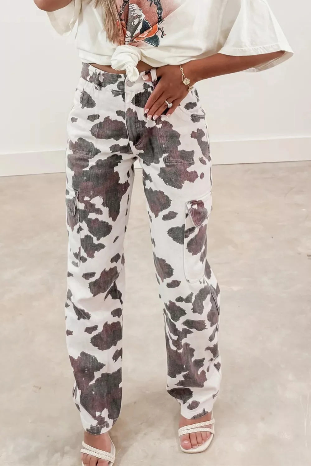 Cow print utility jeans with cargo pockets, made of cotton blend.