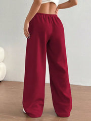 Burgundy wide-leg maternity joggers with elastic waistband and relaxed fit.