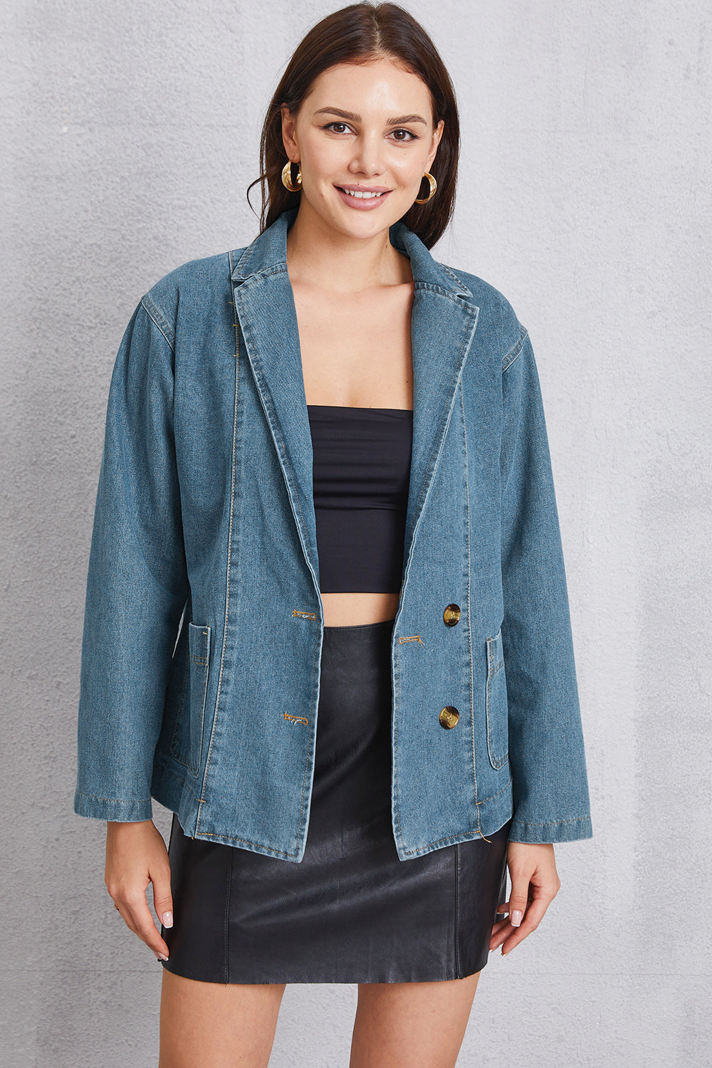 Medium denim blazer with tailored seam detailing and button closure.