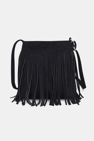 Black suede crossbody bag with long fringe detail and adjustable strap.