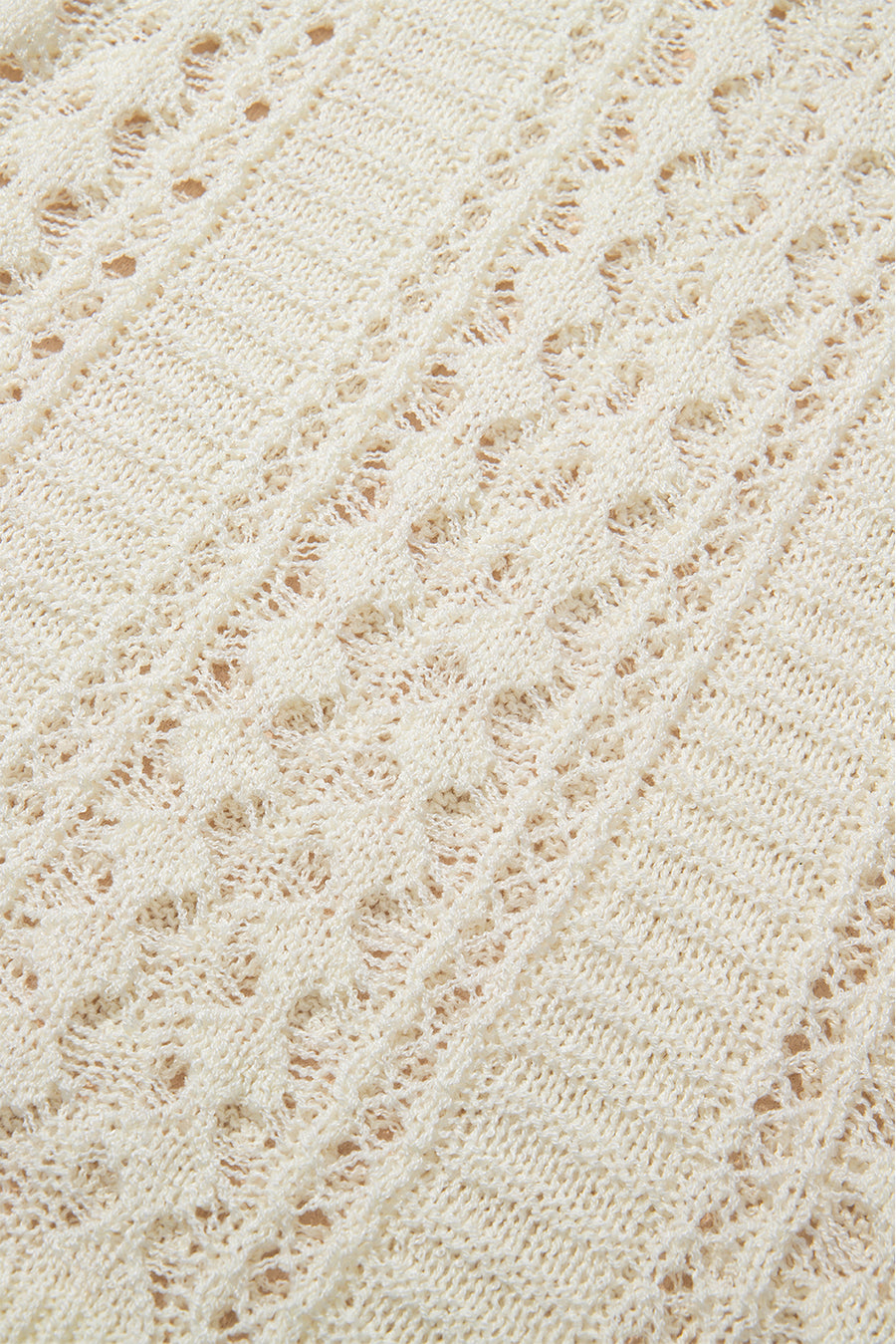 Beige openwork knit beach cover-up with intricate diamond pattern detail.