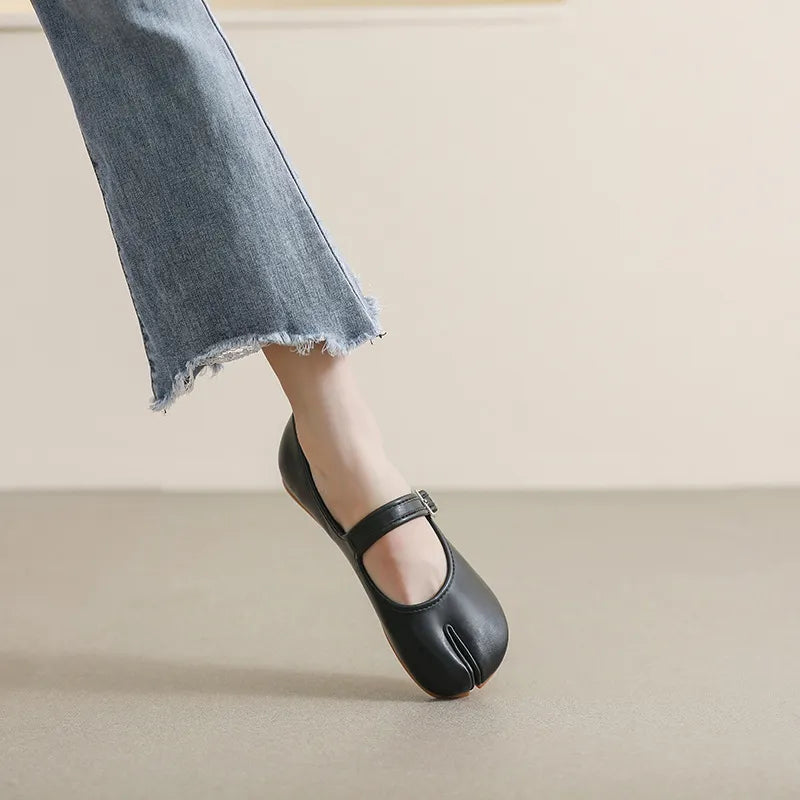 Black leather tabi Mary Jane flats with a single strap and buckle detail.