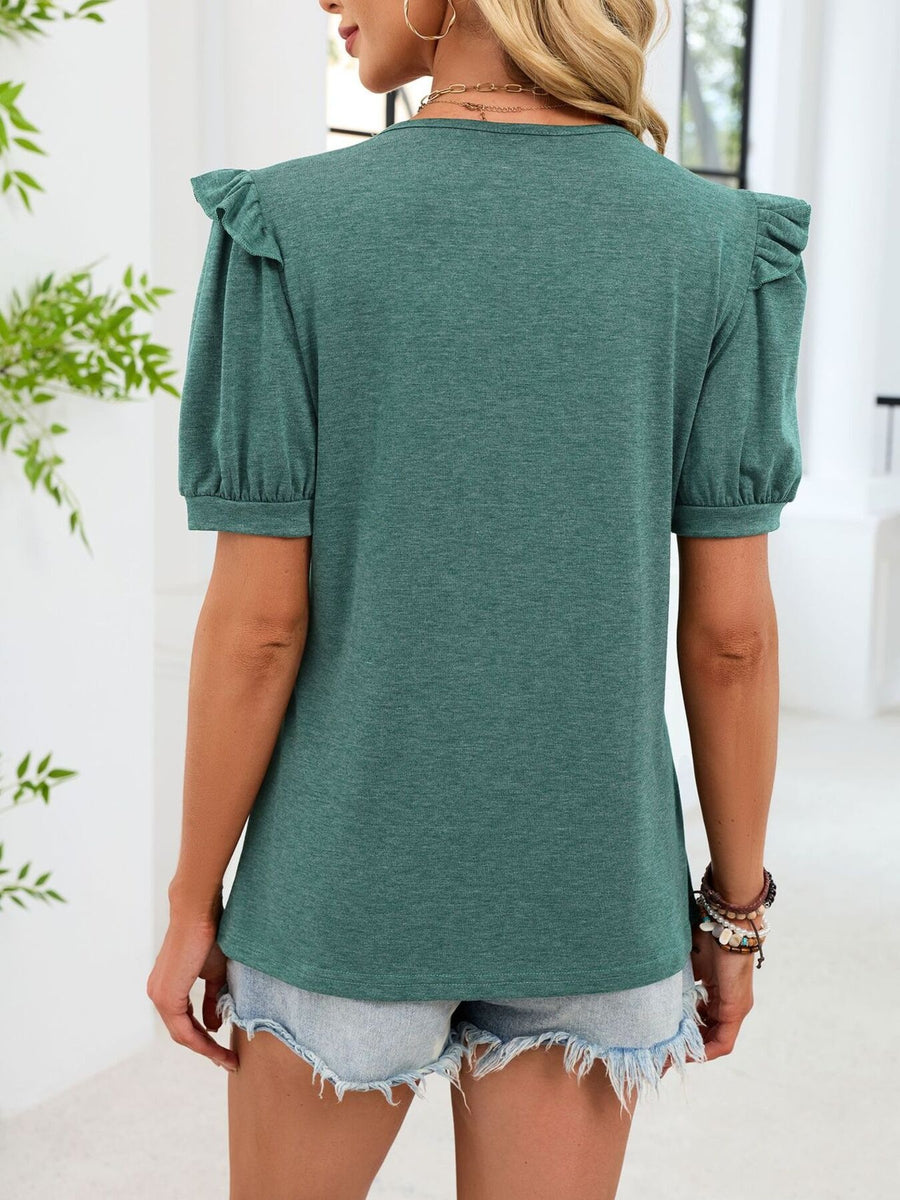 Dark green t-shirt with ruffled short sleeves and a V-neck, paired with denim shorts.