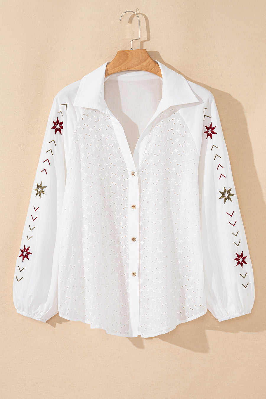White embroidered eyelet blouse with poet sleeves and star details
