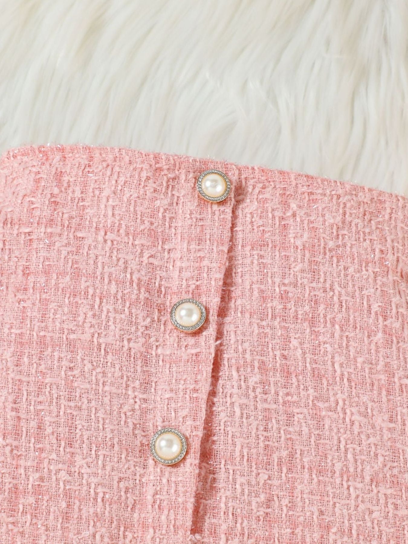 Pink tweed skirt set detail with pearl buttons