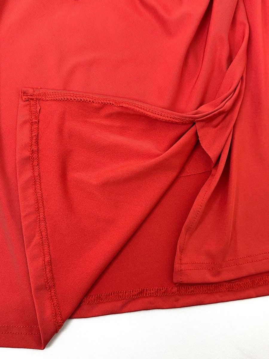 Red jersey wrap skirt with knot detail and visible stitching.