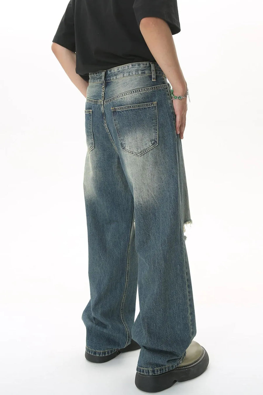 Distressed knee rip wide-leg jeans in medium wash denim with a relaxed fit.
