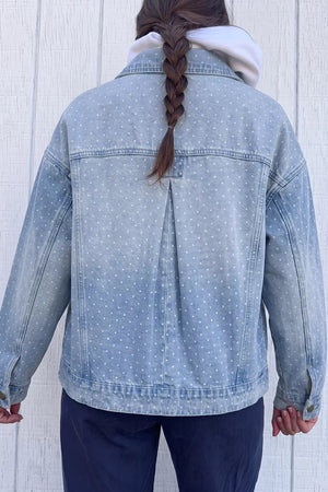 white denim jacket featuring buttoned and polka dot