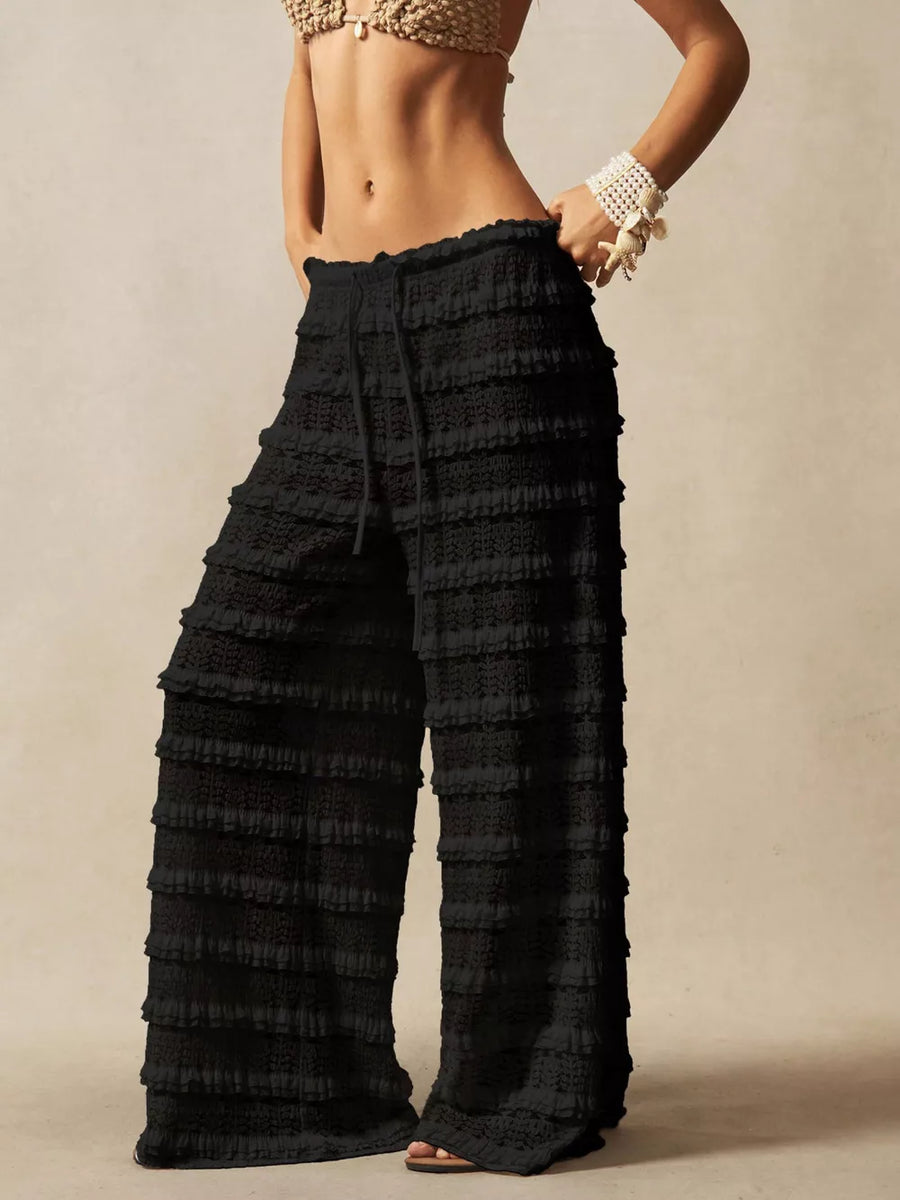 Black crochet wide-leg pants with tiered ruffles and drawstring waist.