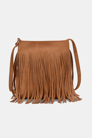 Brown suede crossbody bag with long fringe detail and adjustable strap.