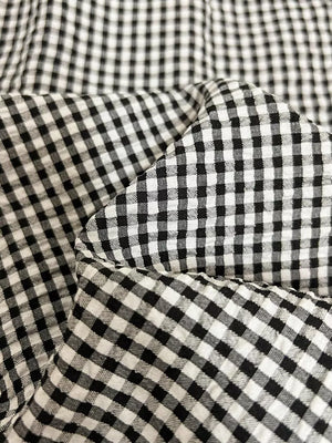 Plaid two-piece ensemble with scalloped trim in black and white gingham fabric.
