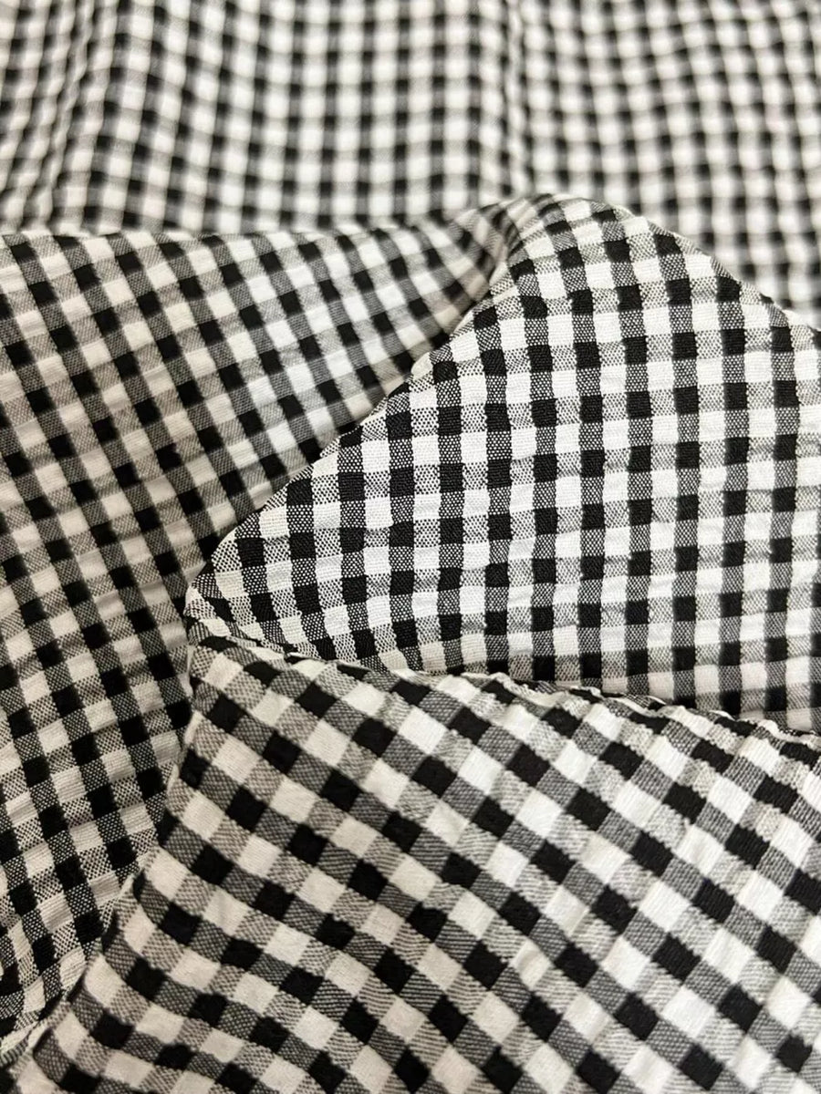 Plaid two-piece ensemble with scalloped trim in black and white gingham fabric.