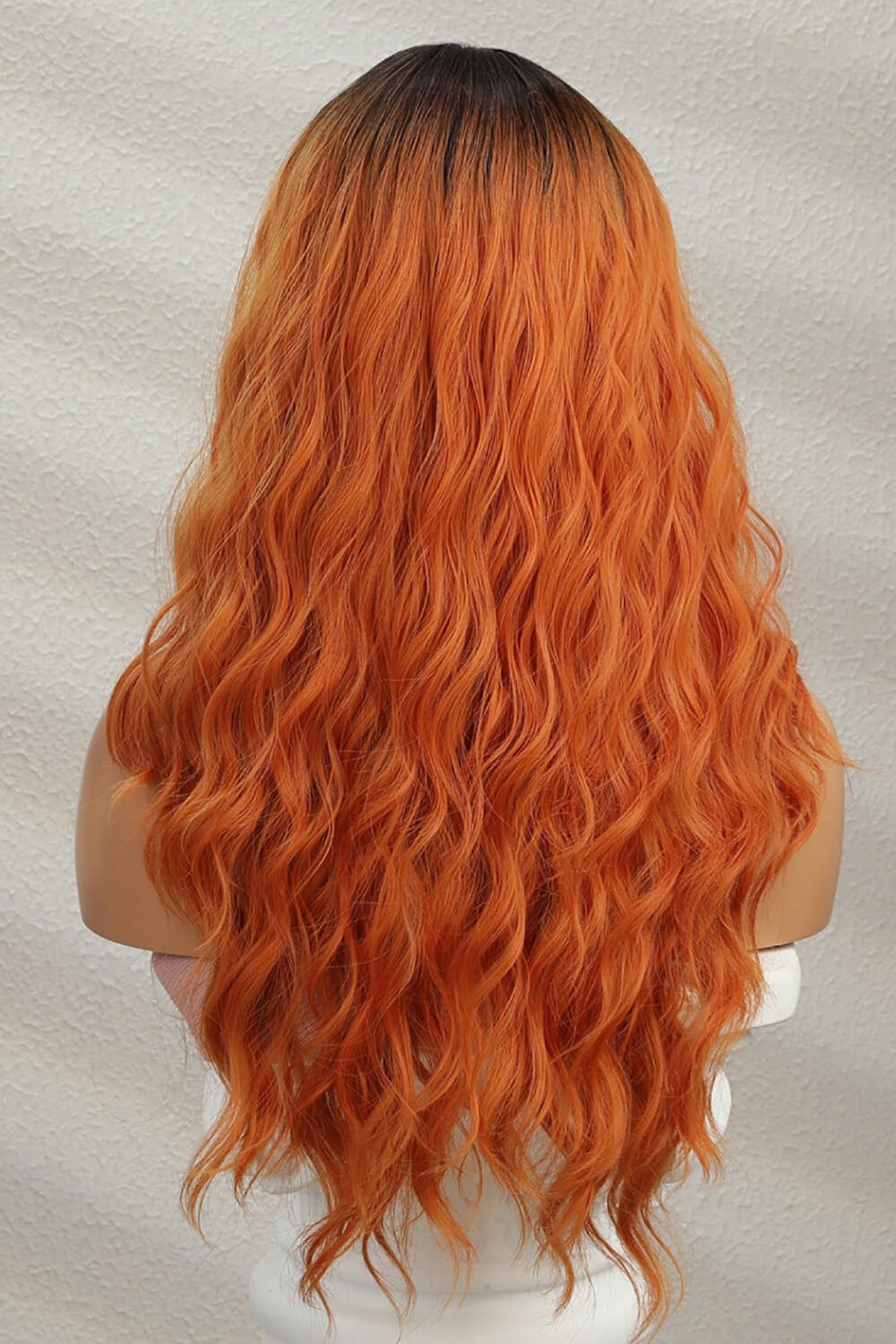 Sunset Ombre lace front wig with ginger/brunette root and wavy copper-orange hair.