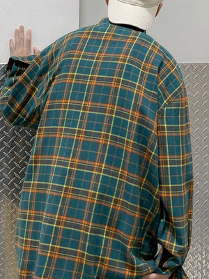 Plus-size long-sleeve shirt in green plaid with orange and yellow accents.