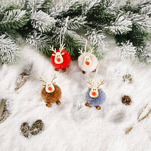 Four multicolor pom-pom reindeer ornaments with wooden antlers and red noses on snow.