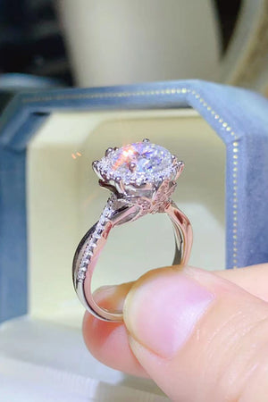 Silver moissanite engagement ring with halo and pave band.