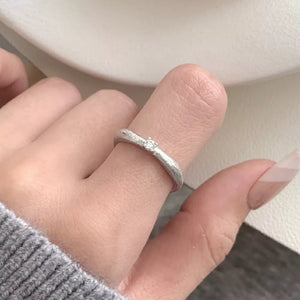 silver ring with textured finish and null