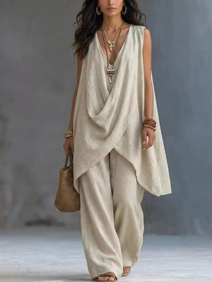 Off-white asymmetrical sleeveless top and wide-leg pants set with V-neckline.