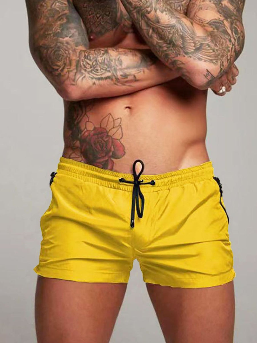 Yellow swim shorts with black drawstring and side trim