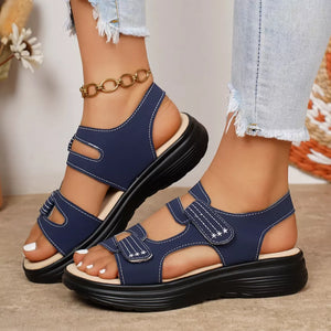 Blue platform sandals with adjustable straps and white stitching detail.