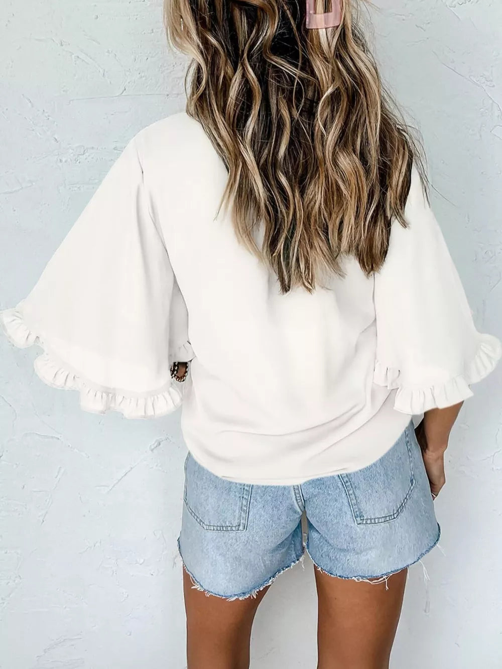 White ruffled mock neck half sleeve shirt with flared sleeves.