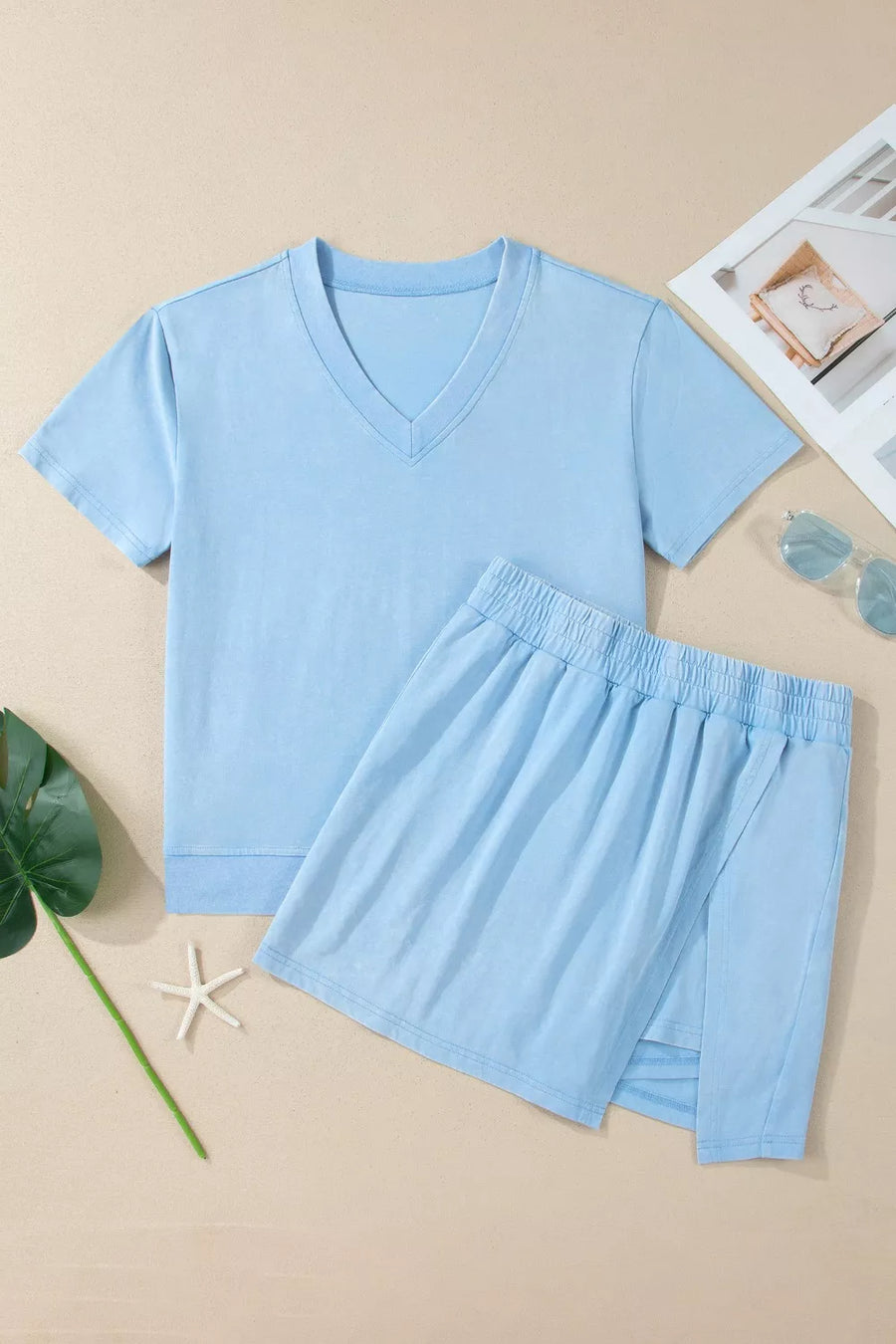 Light blue cotton V-neck top and elastic waist skort set with side slit detail.