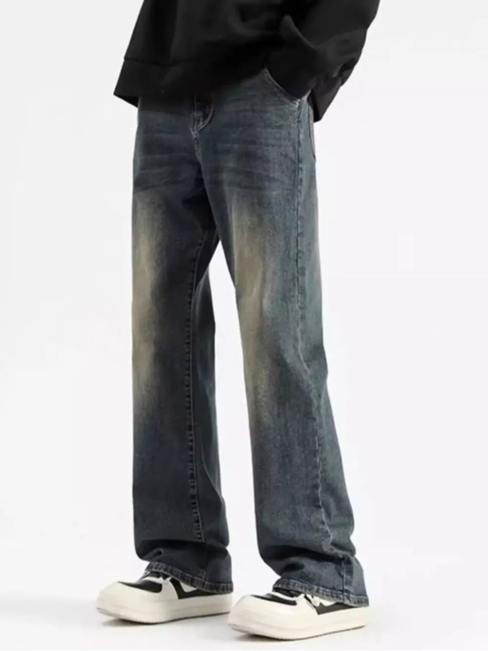 Men's relaxed fit jeans in a heritage wash denim with a distressed look.