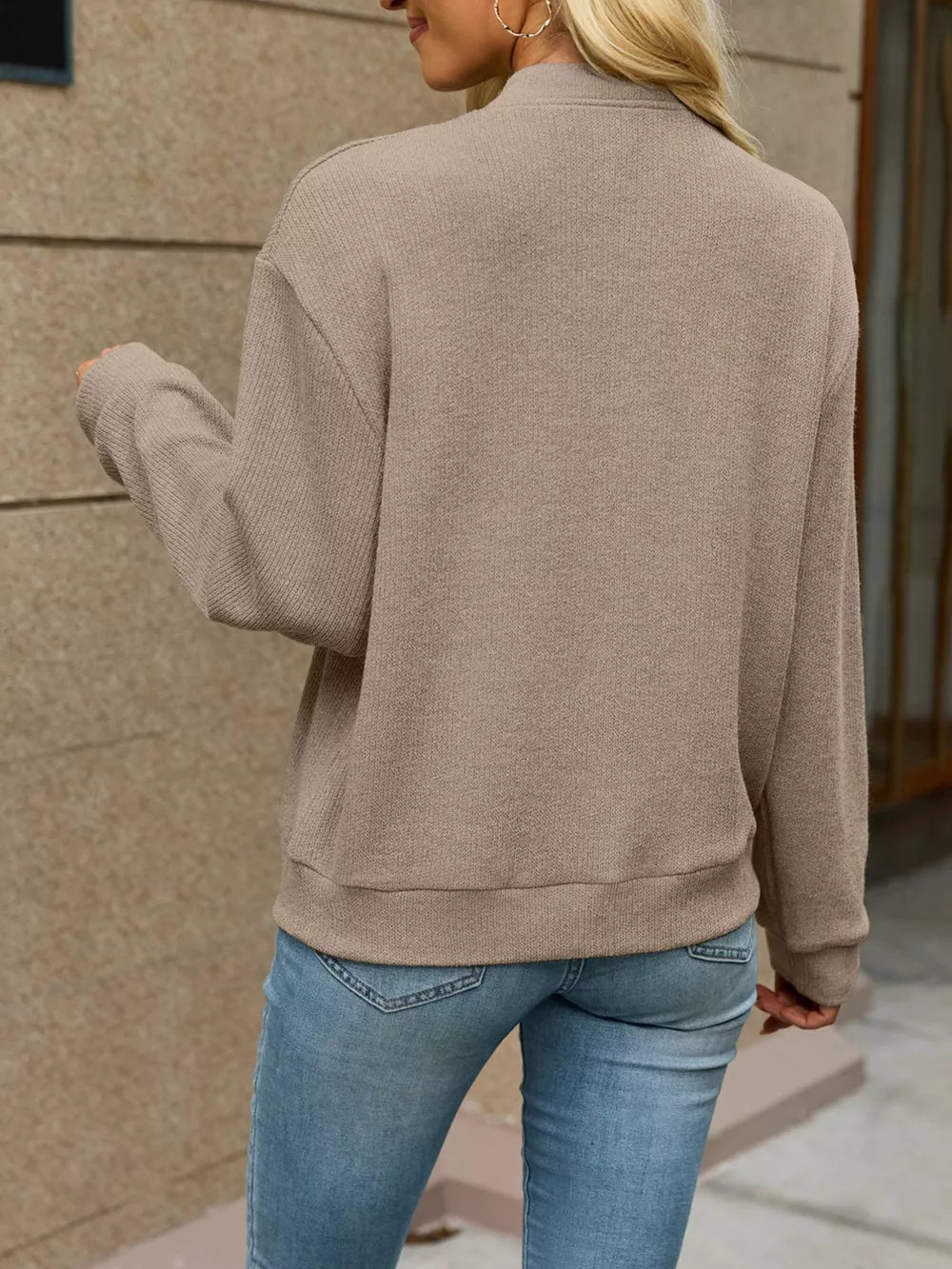 Pink zip-up sweater with hip-length and zip-front