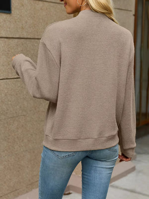 Pink zip-up sweater with hip-length and zip-front