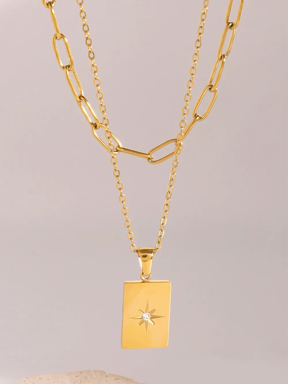 Gold celestial pendant layered chain necklace with starburst detail