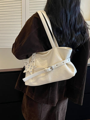 shoulder bag in ivory featuring star charm and relaxed fit