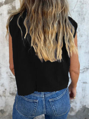 Black button-down cap sleeve shirt with cropped length, styled with jeans.